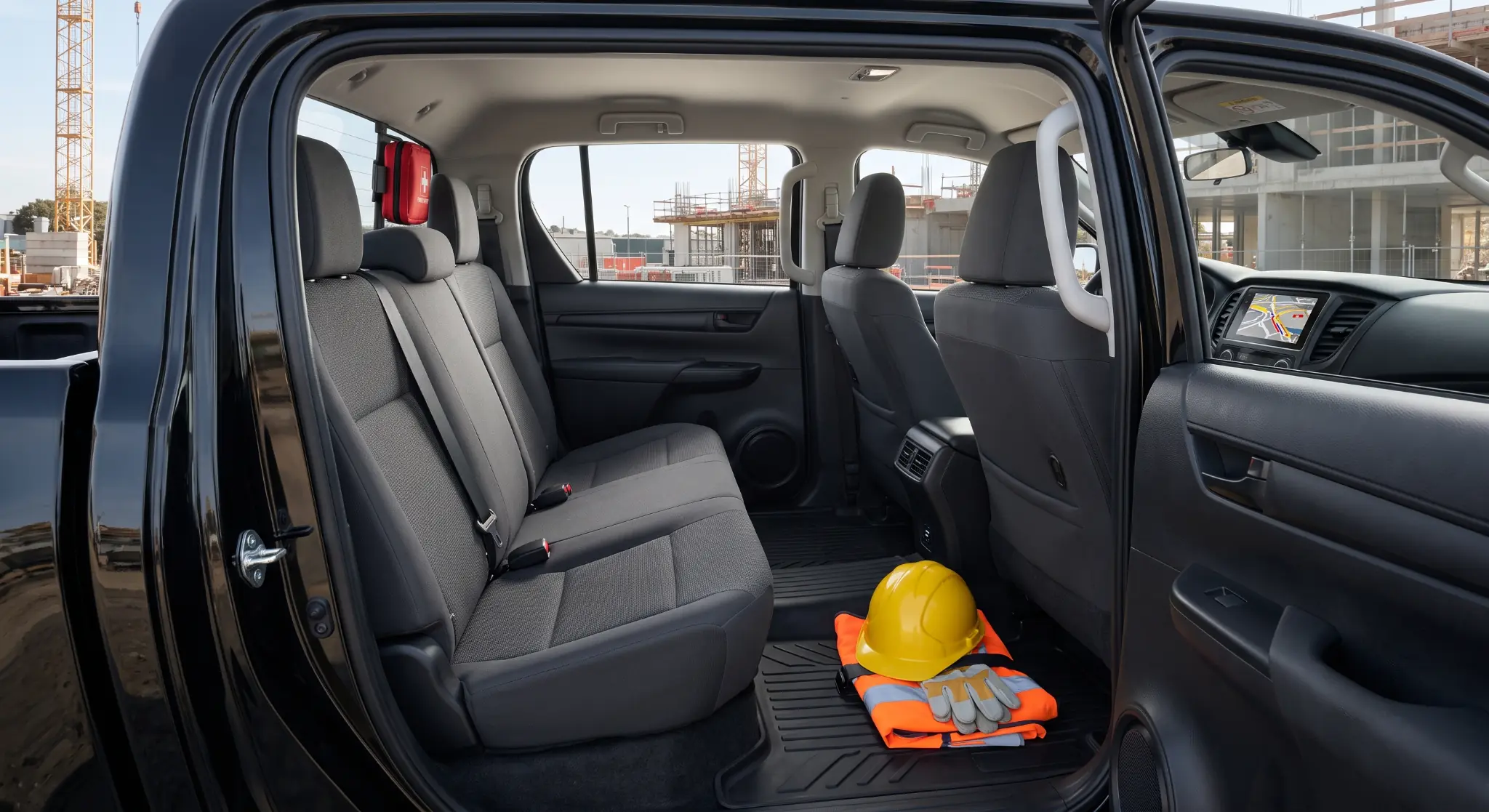 Durable double-cab pickup interior with PPE storage, charging and site route display